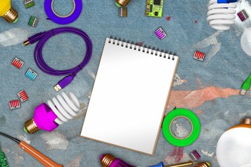 Collage of electric tools on dirty jeans in paint with copy space on blank paper and usb cables, soldering irons, powersave lamps, cleats, insulating tape. electrician office table 3d illustration