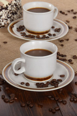 cups of coffee and milk and roasted coffee beans and cake