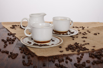 cups of coffee and milk and roasted coffee beans