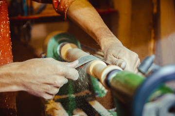 sanding wood on a lathe