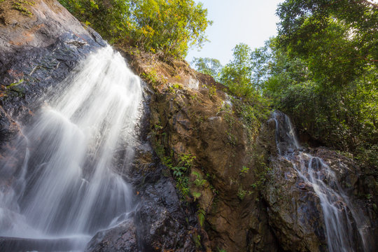 Forest stream waterfall. Waterfall mossy rocks
