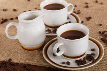 cups of coffee and milk and roasted coffee beans