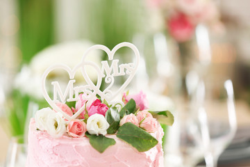 Delicious cake decorated with flowers and hearts for lesbian wedding