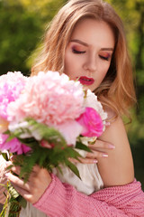 Fototapeta premium Beautiful young woman with bouquet of peonies, closeup