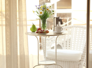 Table with delicious breakfast on the balcony