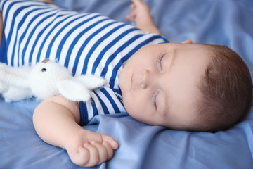 Cute little baby sleeping on bed