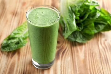 Glass of fresh vegetable smoothie on wooden table