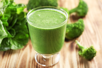 Glass of fresh vegetable smoothie on wooden table