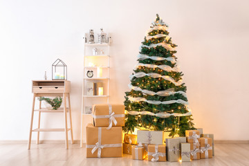 Beautiful Christmas tree with gift boxes in interior of living room