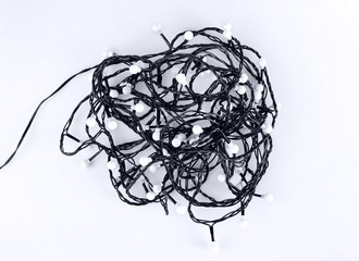 Tangled Christmas garland on white background