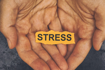 Person holds piece of paper with word Stress