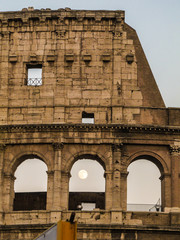 Rome - Circa June 2015: Detail of the Coliseum and a full moon in the background
