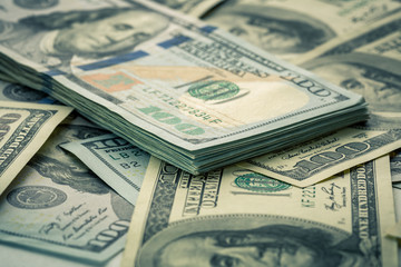 Lot of one hundred dollar bills close-up background