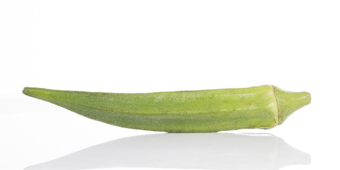Single fresh okra isolated on white background.