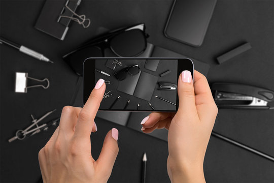 Shooting black stationery on phone's camera. Stationery on black background.