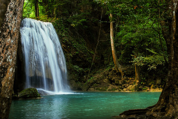 Fototapeta na wymiar waterfall in the tropical forest where is in at Erawan National Park, Thailand