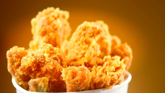 Fried chicken wings and legs. Bucket full of crispy kentucky fried chicken. Rotation 360 degrees. 4K UHD video footage. Ultra high definition 3840X2160