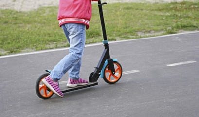 The girl on the scooter.