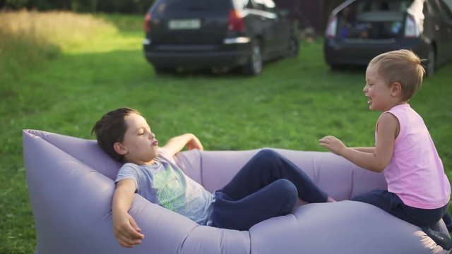 boys playing on an inflatable sofa