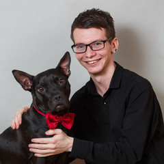 The young man and american staffordshire terrier portrait