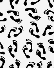 Fototapeta na wymiar Seamless pattern of black silhouettes of prints of human feet