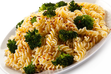 Pasta with herbs and broccoli on white background