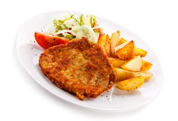 Fried pork chop, chips and vegetable salad