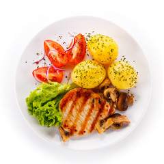 Roast steak with potatoes on white plate
