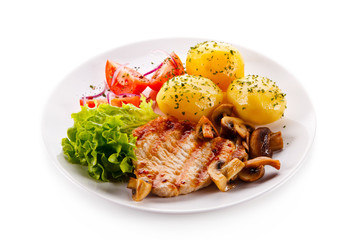 Roast steak with potatoes on white plate