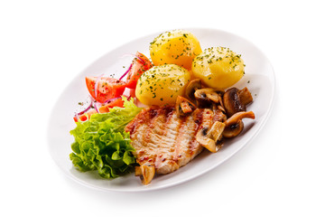 Roast steak with potatoes on white plate