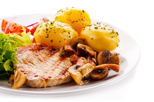 Roast steak with potatoes on white plate