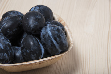 Summer fruits ripe plums in a bowl