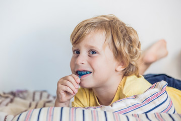 Three-year old boy shows myofunctional trainer to illuminate mouth breathing habit. Helps equalize...