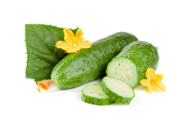 Sliced cucumber with leaf and flower isolated on a white background