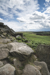 Beautiful vibrant landscape image of Burbage Edge and Rocks in Summer in Peak District England