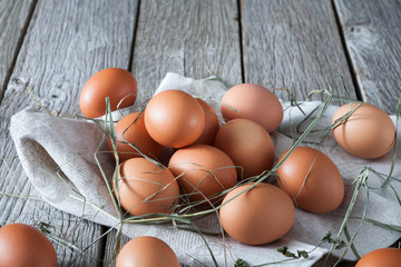 Fresh chicken brown eggs on rustic wood, organic farming concept