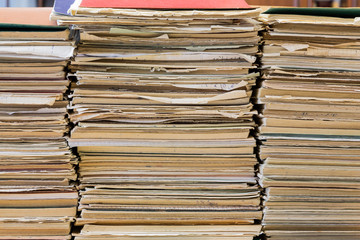 A stack of old school notebooks. Multicolored cover.