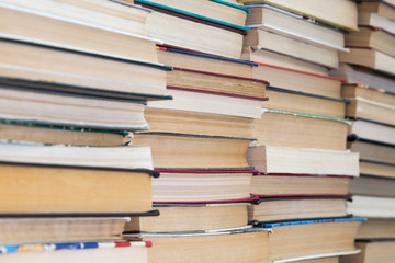 A stack of books with colorful covers. The library or bookstore. Books or textbooks. Education and reading.