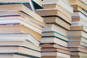 A stack of books with colorful covers. The library or bookstore. Books or textbooks. Education and reading.