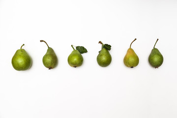Row of ripe green pears isolated on a white background. Top view