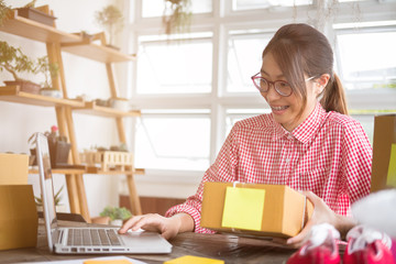 business owner packing cardboard box at workplace. freelance woman seller prepare parcel box of product for deliver to customer.  Online selling, internet marketing, e-commerce, shipping concept