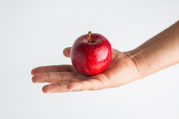 close-up view of a hand holding apple on a white background