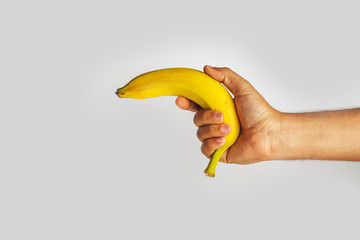 hand holding a banana on a white background