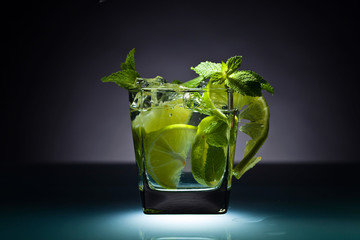 Cocktail with lime, ice and peppermint .