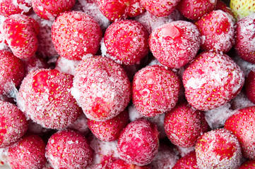 Frozen strawberries with ice background pattern