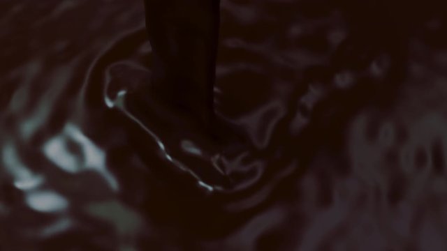 Gorgeous closeup of silky chocolate syrup as it's being poured. 4K UHD rendered at 16-bit color depth.