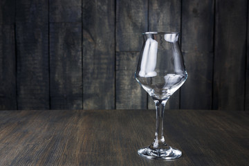 Empty glass on dark wooden background