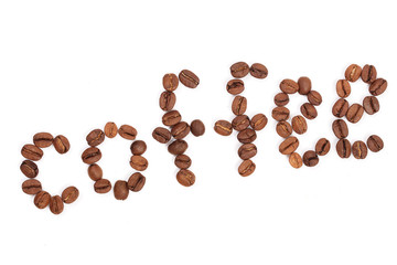 Coffee inscription composed of roasted coffee beans on white background
