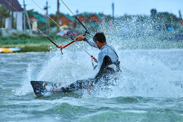Kitesurfing on waves at sea in summer.