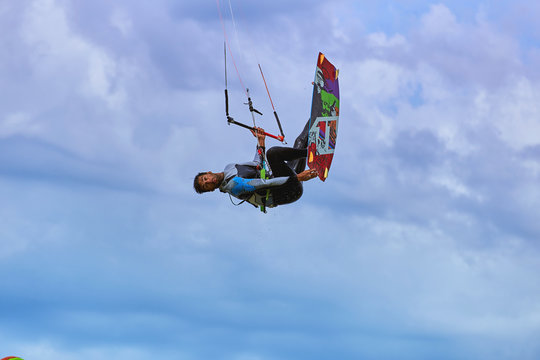 Kitesurfing on waves at sea in summer.